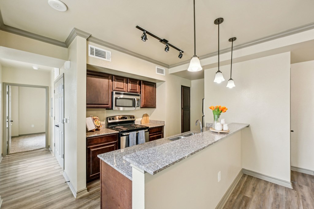 A kitchen with a counter and a microwave.