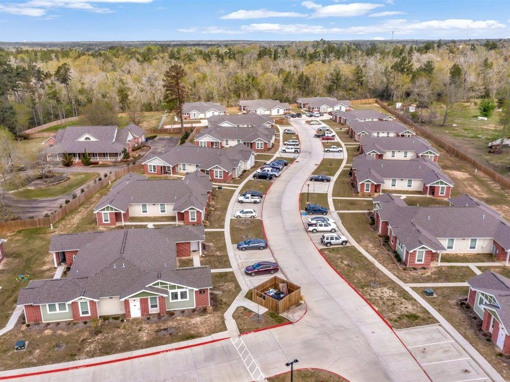 A suburban neighborhood with houses and cars parked in the driveways.