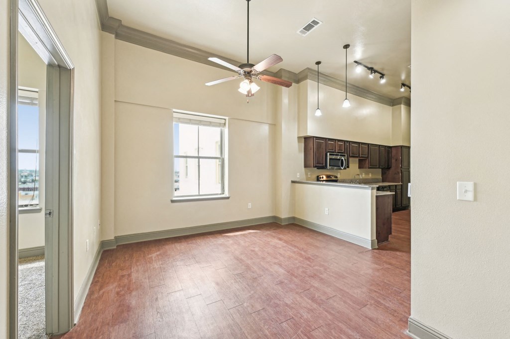 A room with a ceiling fan and a window.