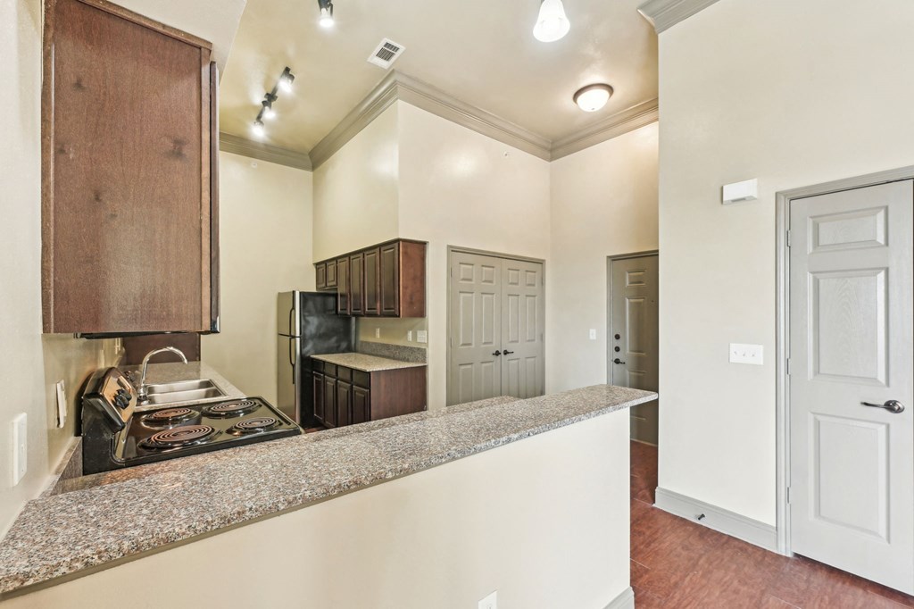 A kitchen with a stove top oven and a counter top.