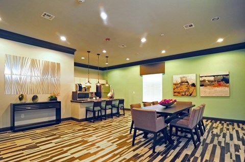 A dining room with a table set for six.