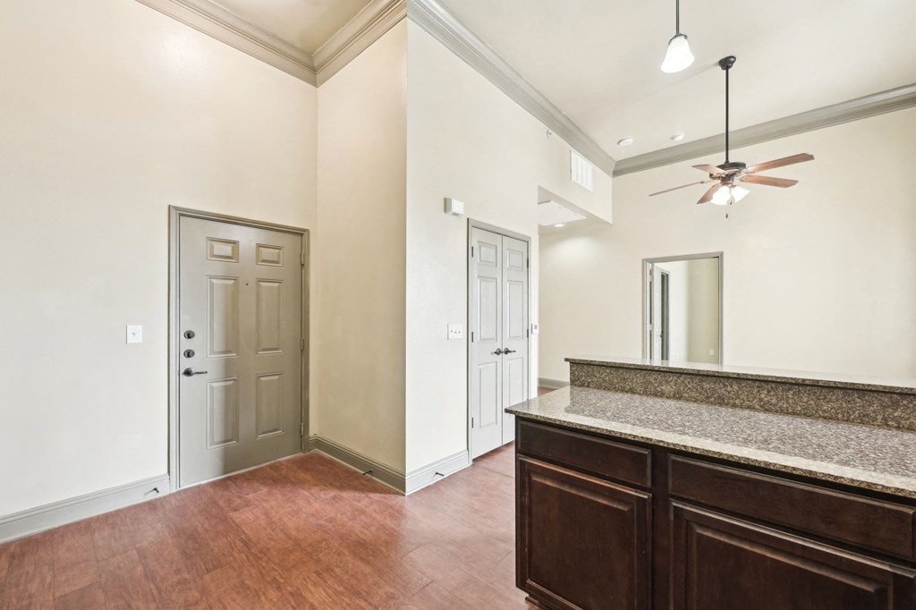A room with a wooden floor and a marble countertop.