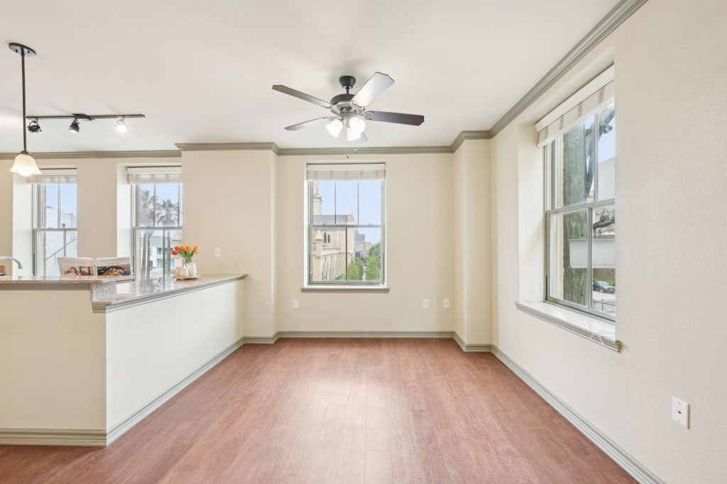 A room with a ceiling fan and a window.