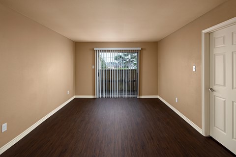 A room with wooden floors and a white door.