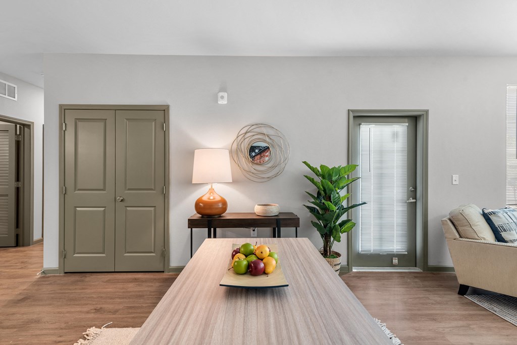 a living room with a table with a bowl of fruit on it