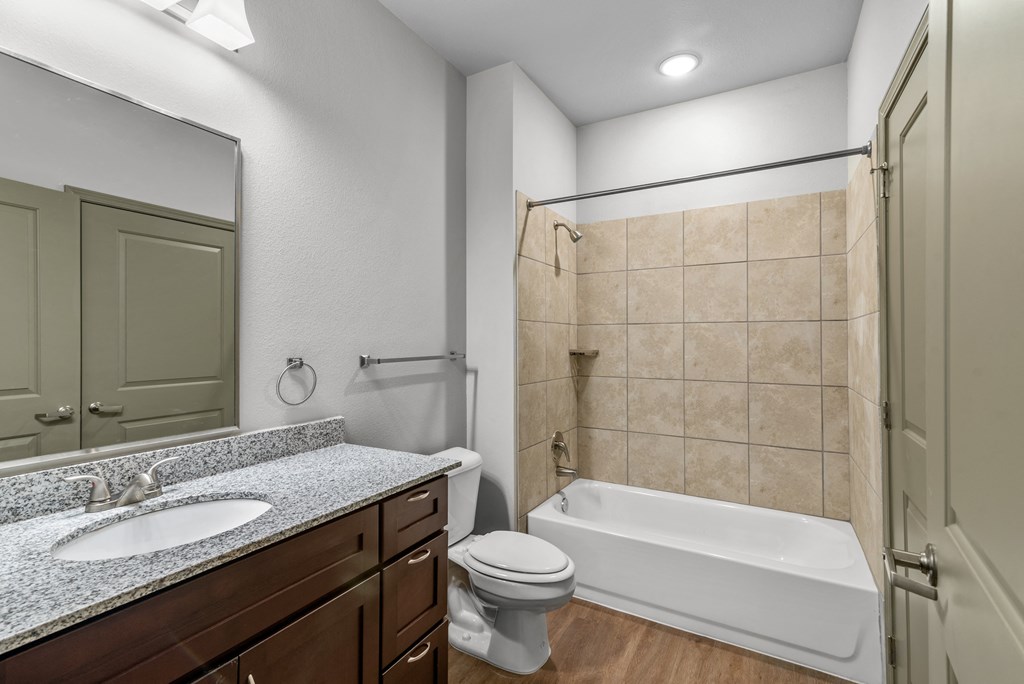 a bathroom with a shower toilet and sink and a tub
