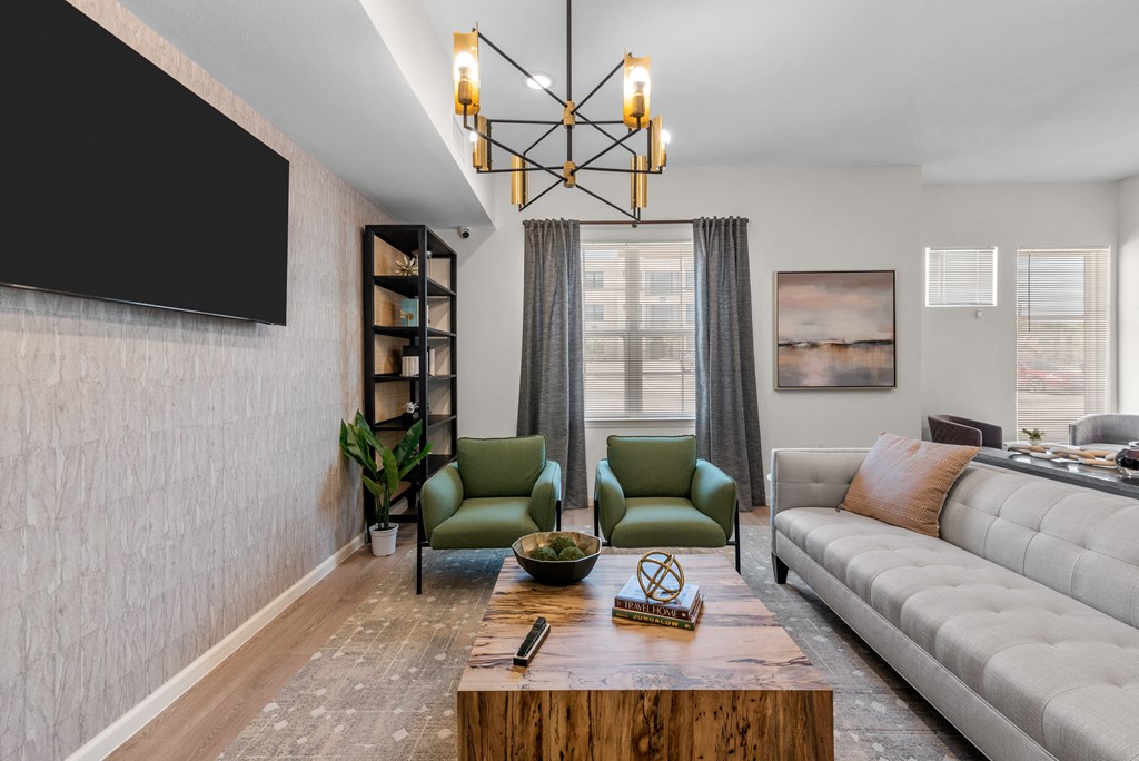 a living room with a couch and chairs and a coffee table