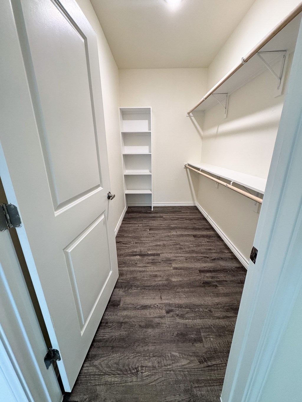 A white door is closed with a black handle.