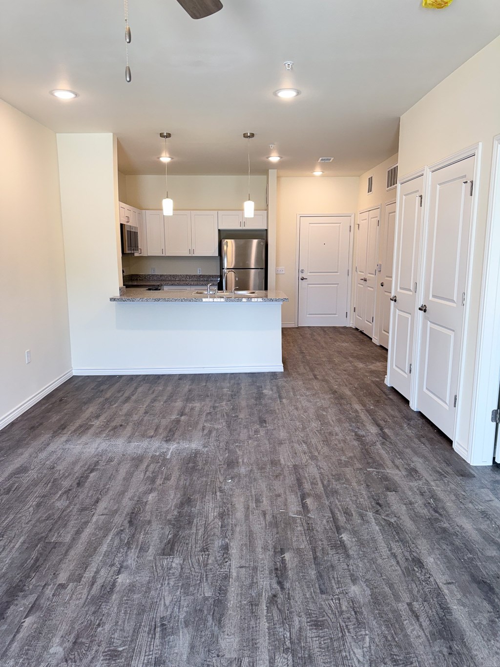 A kitchen area with a counter and cabinets.