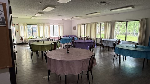 A room with tables and chairs set up for an event.