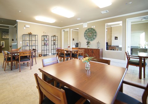 A dining room with a wooden table and chairs.