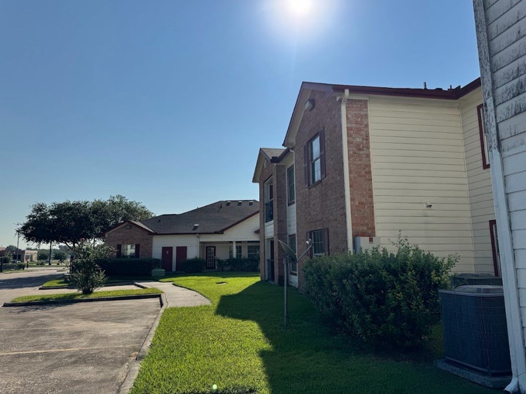A sunny day at a residential area with houses and green lawns.