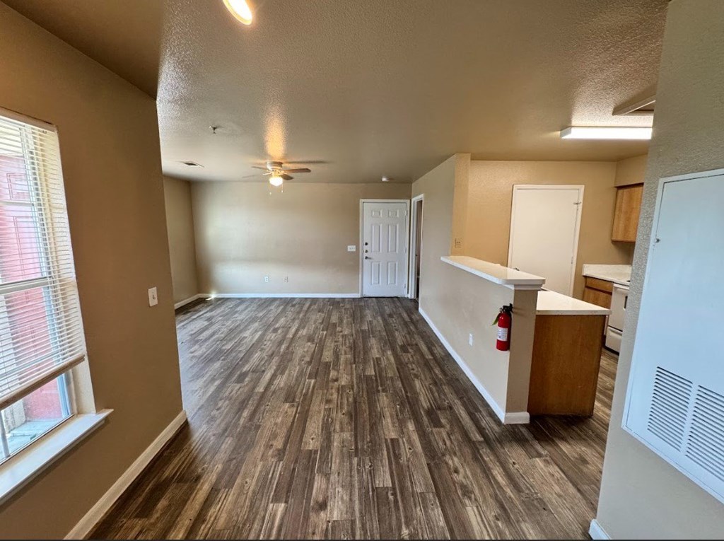 A room with a wooden floor and a ceiling fan.