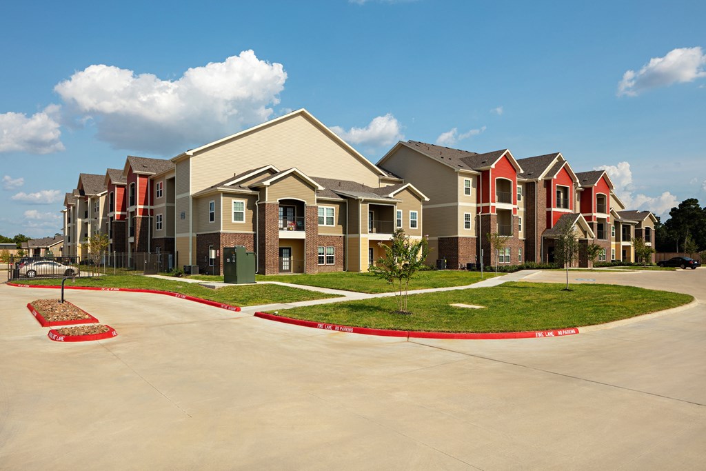 a row of townhouses with a parking lot in front of them