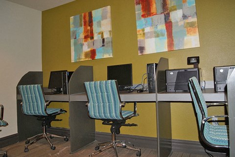 A room with yellow walls and a painting on the wall.