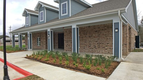 A house with a red line on the sidewalk in front of it.