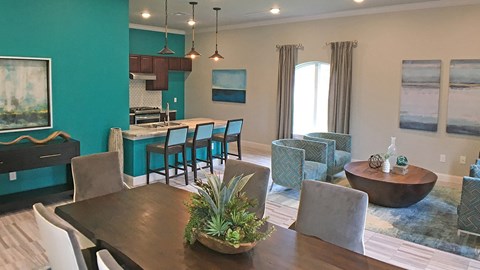 A dining room with a wooden table and chairs.
