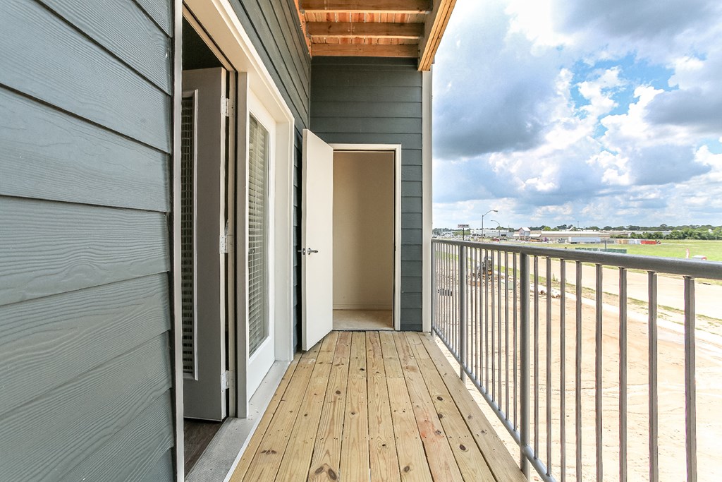 a balcony with a door that leads to a room