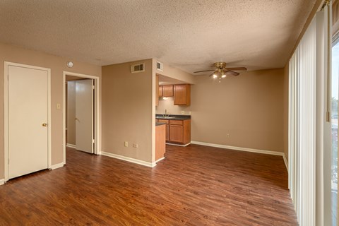A room with wooden floors and a ceiling fan.