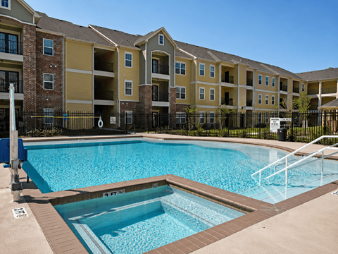A swimming pool in front of apartment buildings.