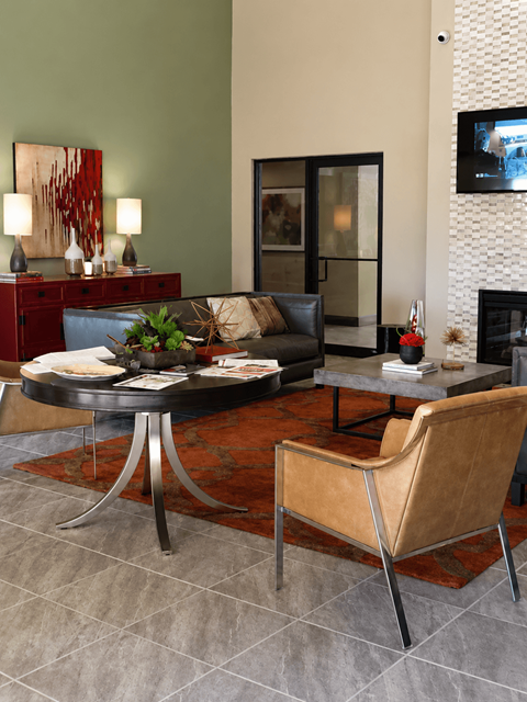 A living room with a black table and a brown chair.