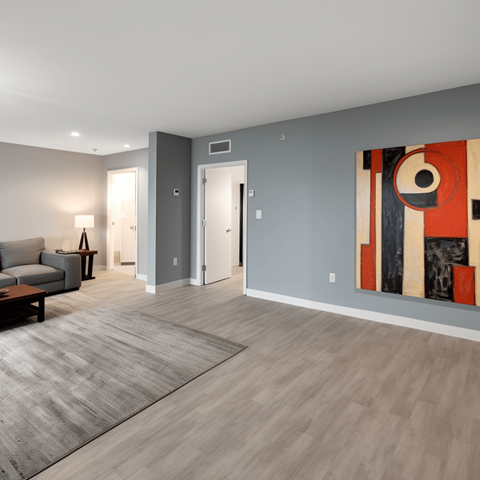 a living room with a couch and a painting on the wall