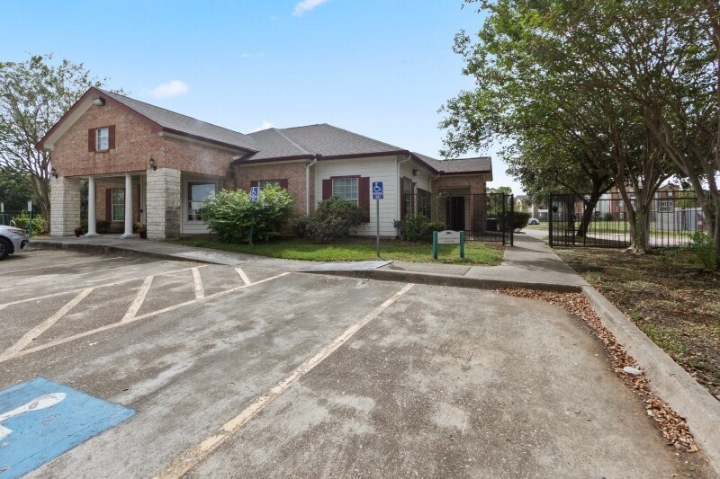 A parking lot with a handicap sign painted on the pavement.