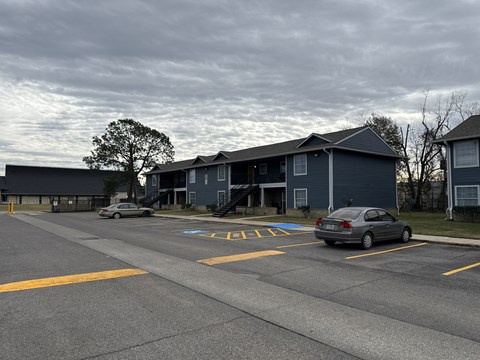 A grey car is parked in a parking lot.