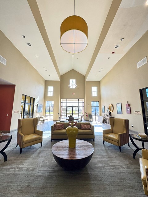 A large room with a long table and chairs.