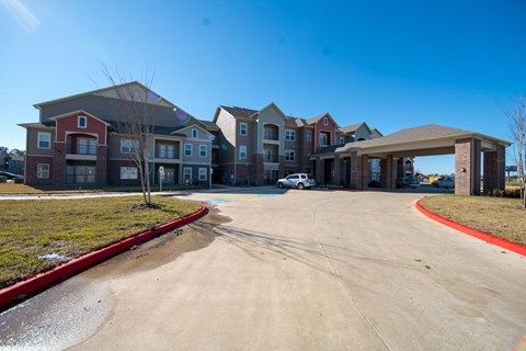 A row of houses with a white car parked in front of them.