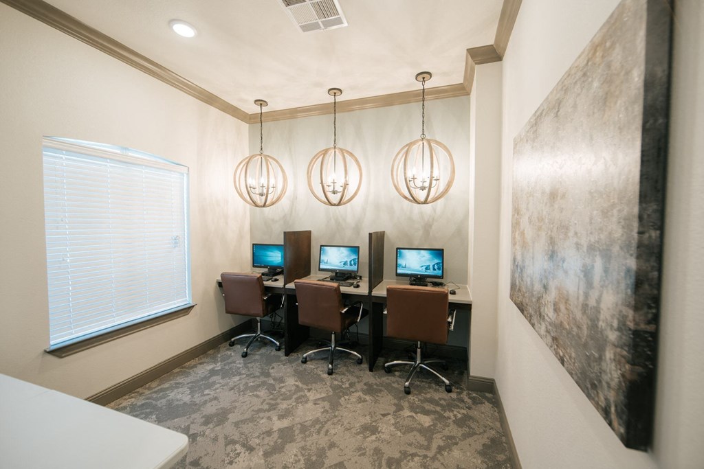 a room with three computers on a table