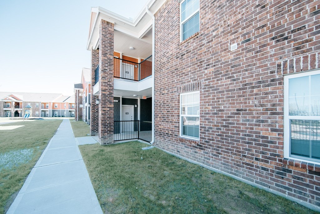 a view of the exterior of a building at the whispering winds apartments in pearland, tx