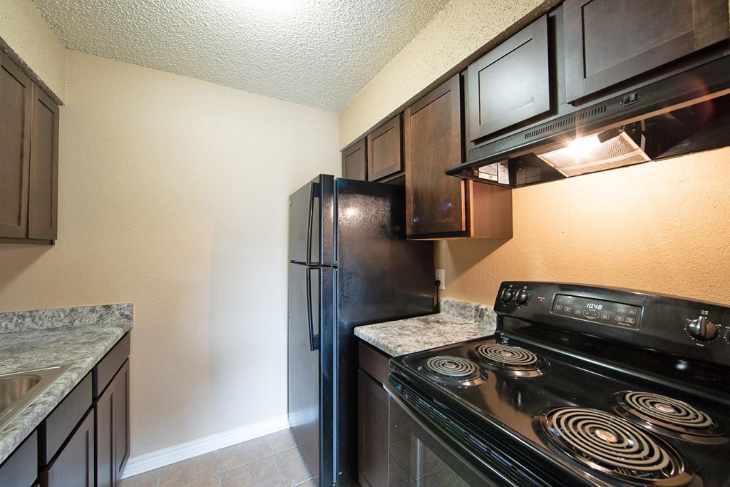 a kitchen with a stove and a refrigerator