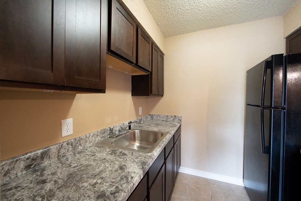a kitchen with a sink and a refrigerator