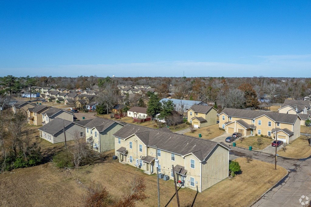 an aerial view of a neighborhood of yellow houses