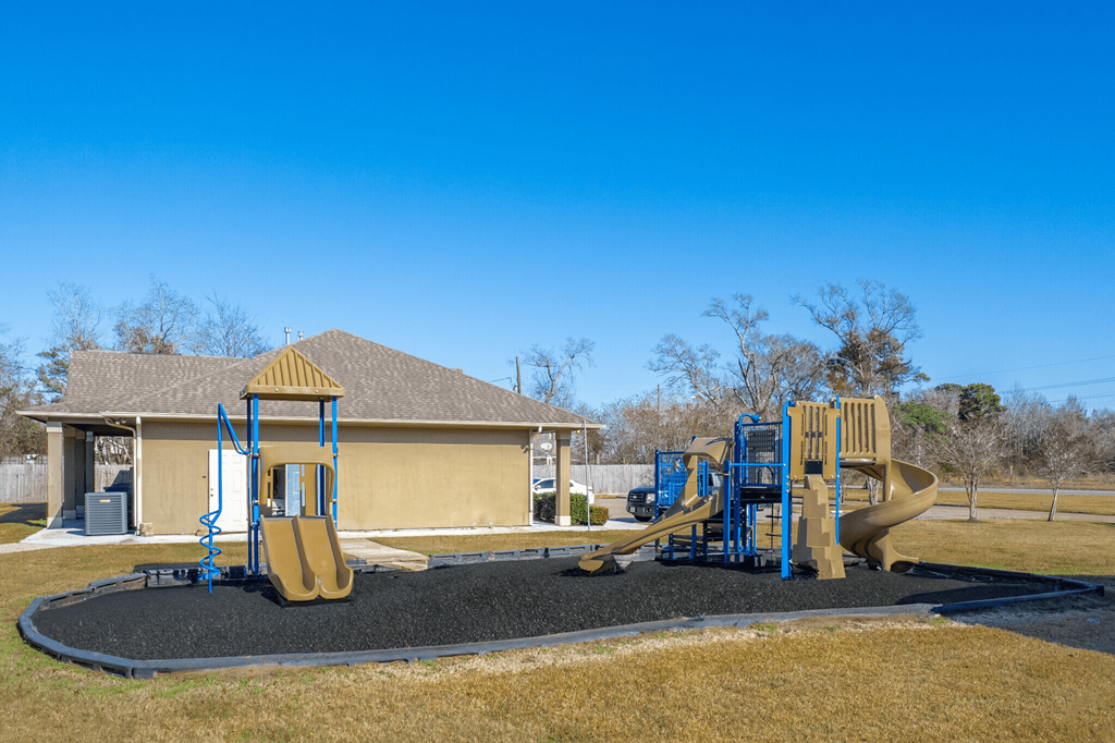 our playground is in front of a yellow house
