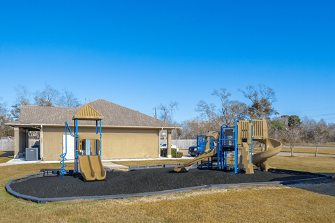our playground is in front of a yellow house
