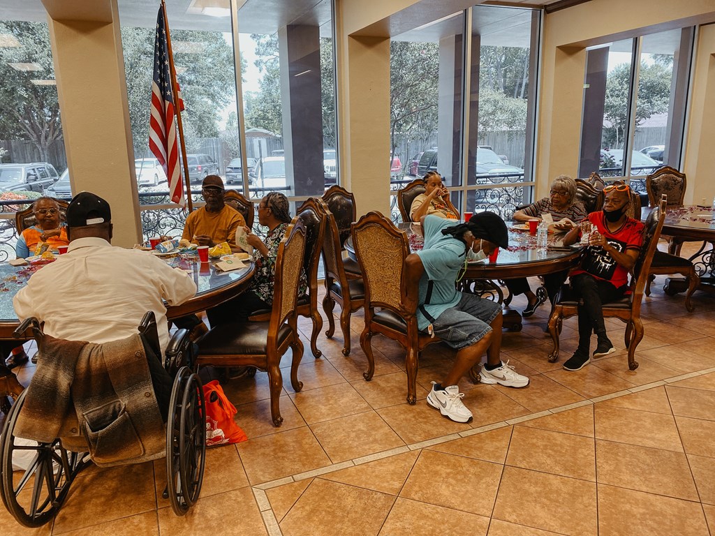 a group of people sitting at a table eating food