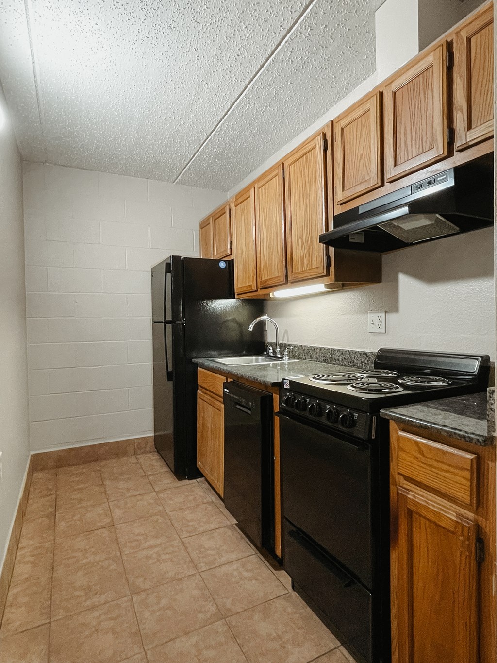 a kitchen with black appliances and wooden cabinets