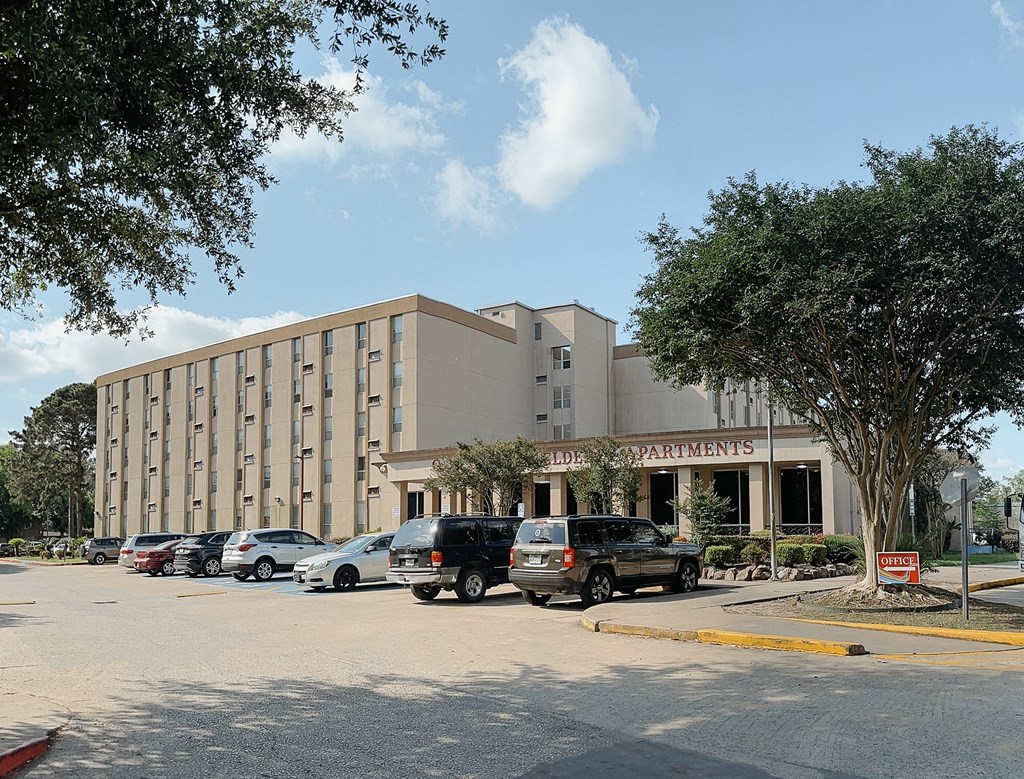 a large building with a parking lot in front of it