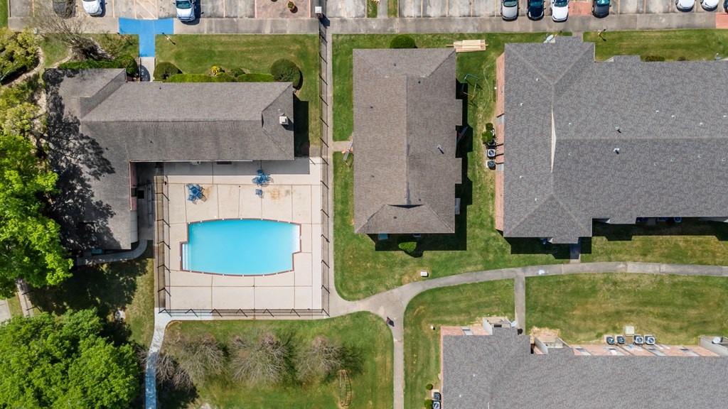 a birdseye view of a house with a large pool in the backyard