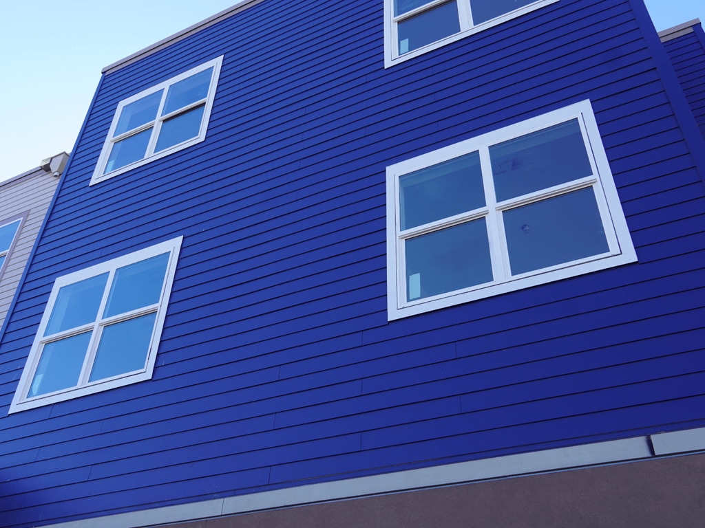 A blue building with white windows.