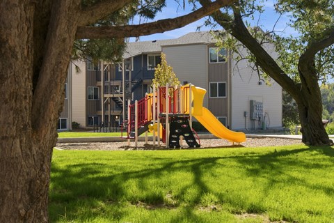 playground with yellow slide at Gateway Village Apartments in Fort Morgan, CO, 80701
