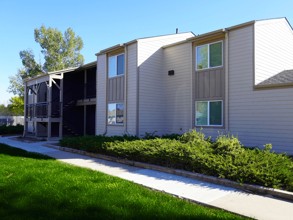 A building with a grey siding and a white roof.