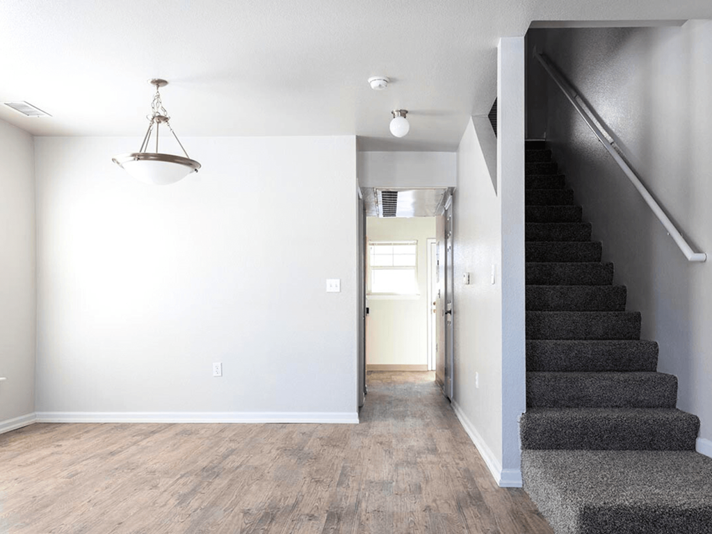A room with a staircase leading to the upper floor.