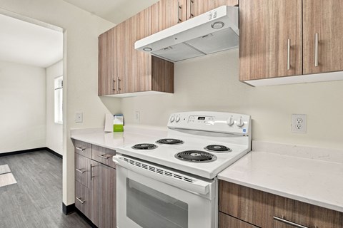 A white stove top oven with a glass door sits on a counter in a kitchen at Gateway Village Apartments in Fort Morgan, CO, 80701