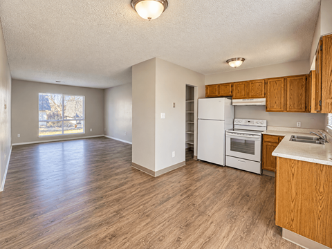 A kitchen with wooden cabinets and white appliances.