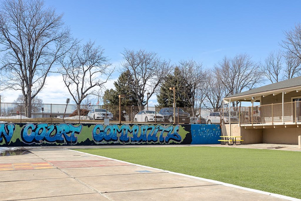 a wall with graffiti in front of a building at Garden Court, Denver, Colorado, 80220