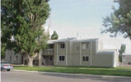 a white building with a car parked in front of it