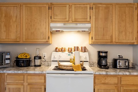 A kitchen with a stove top oven and a toaster.